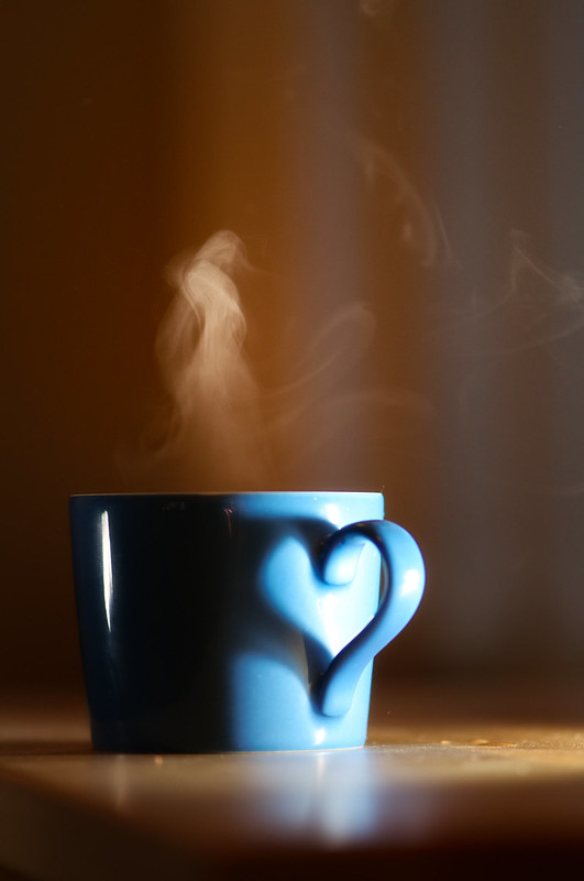 A cup of green tea in a small, porcelain cup